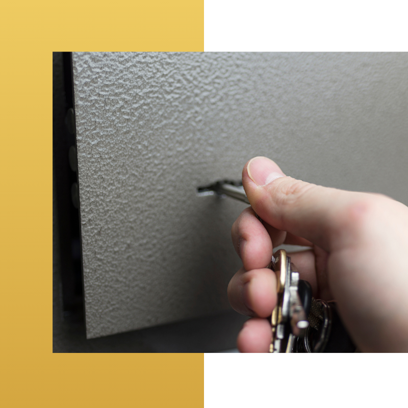Inserting Key Into Safety Deposit Box